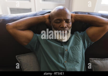 Senior man sleeping in living room Stock Photo