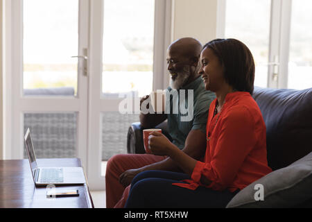 Senior couple making video call on laptop in living room Stock Photo