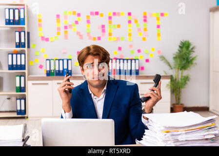 Young employee suffering from excessive work Stock Photo