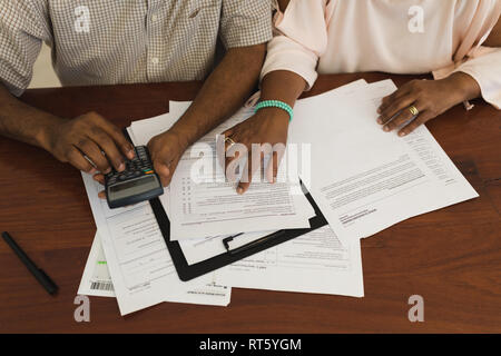 Senior couple discussing over invoices at home Stock Photo
