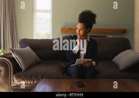 Female real estate agent using digital tablet in living room Stock Photo