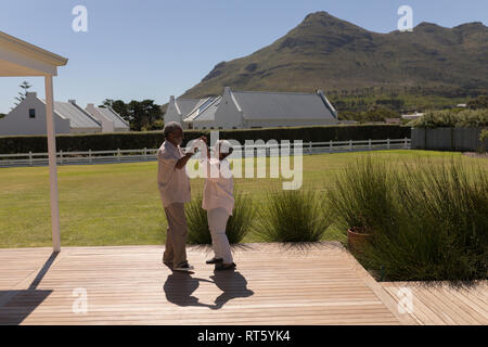 Senior couple dancing in the backyard of home Stock Photo