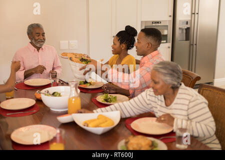 Multi-generation family having meal together Stock Photo