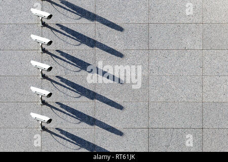 security video surveillance cameras in a row at marble wall background.. Stock Photo