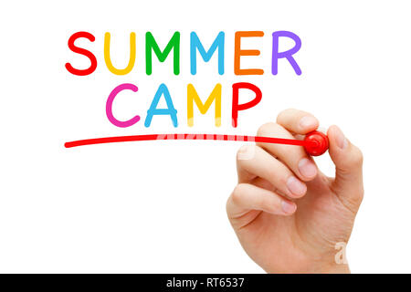 Hand writing Summer Camp with marker on transparent wipe board. Supervised program for children or teenagers during the summer holiday period. Stock Photo