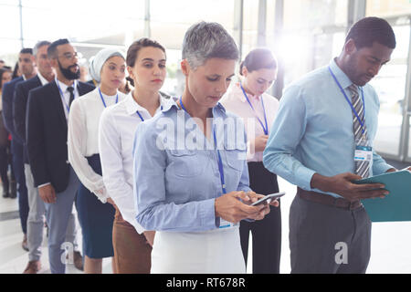 Office employee standing in queue up to drink water form water ...