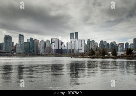 Vancouver city skyline, view from Stanley Park waterfront path across the Vancouver Harbour on a winter day, Vancouver, Canada Stock Photo