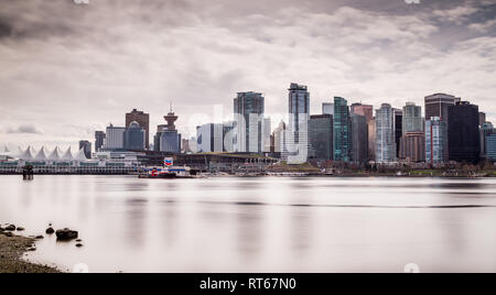Vancouver city skyline, view from Stanley Park waterfront path across the Vancouver Harbour on a winter day, Vancouver, Canada Stock Photo