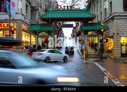 Feb 27, 2019 - San Francisco CA:   Cars drive past the famous Dragon Gate that leads into Chinatown on a rainy afternoon. Stock Photo