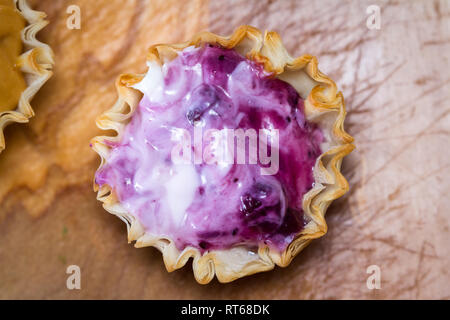 baked phyllo dough cups filled with a fresh berry and yogurt mixture as a sweet treat Stock Photo