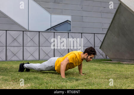 Young man during workout, pushup Stock Photo