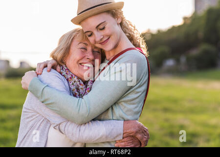 Happy grandmother and granddaughter hugging each other Stock Photo