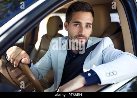Successful young businessman driving in his car Stock Photo
