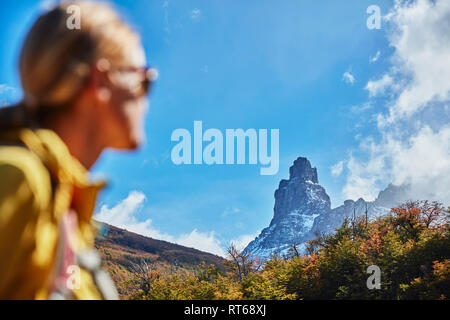 Chile, Cerro Castillo, woman on a hiking trip looking at mountain top Stock Photo