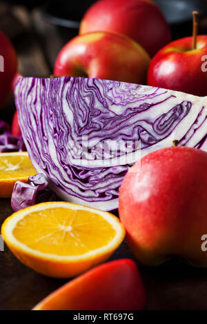 Sliced red cabbage, red apples and sliced orange Stock Photo