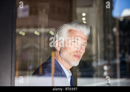 Portrait of a mature man, looking out of window Stock Photo