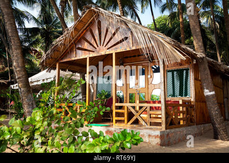 Tropical cottage on the beach with balcony and palm trees in Goa, India Stock Photo