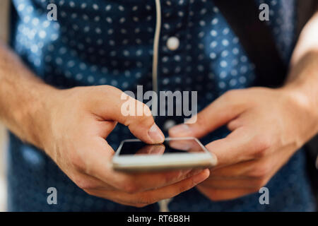 Man' hands using smartphone, close-up Stock Photo