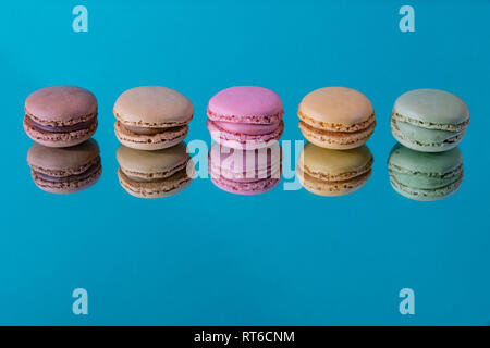 Tasty colorful macaroon homemade isolated on a mirror and a colorful background and reflections contemporary decoration Stock Photo