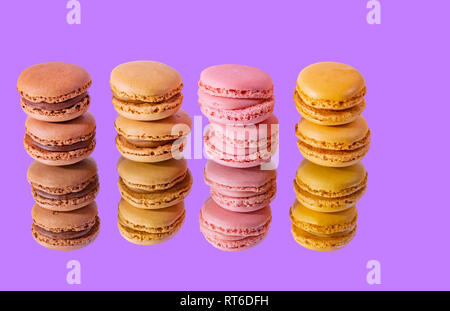 Tasty colorful macaroon homemade isolated on a mirror and a colorful background and reflections contemporary decoration Stock Photo