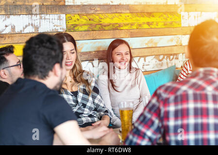 Young friends having great time in trendy pub restaurant. Stock Photo