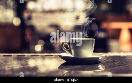 Cup of coffee on bar desk in night club. Stock Photo