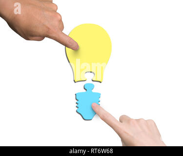 Woman and man two hands assembling one bulb shape puzzle of two jigsaw pieces with different color yellow and blue, high angle view, isolated on white Stock Photo