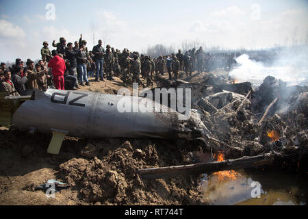 (190228) -- BEIJING, Feb. 28, 2019 (Xinhua) -- People and Indian army troops gather near the wreckage of an Indian aircraft after it crashed at Garend Kalan Village of Budgam, about 34 kilometers south of Srinagar, summer capital of Indian-controlled Kashmir, Feb. 27, 2019. A pilot and a co-pilot of Indian Air Force (IAF) were killed after a Mi-17 jet crashed Wednesday in Indian-controlled Kashmir, Indian officials said. Meanwhile, Pakistan army said on Wednesday the Pakistan Air Force has shot down two Indian fighter jets inside Pakistani airspace and ground troops arrested one pilot of the d Stock Photo