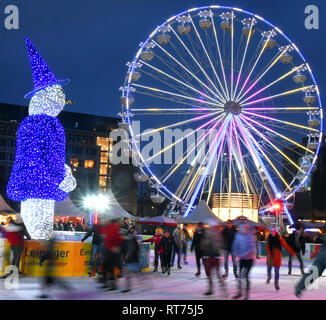 03 February 2019, Saxony, Leipzig: In the middle of the city, many skaters cavort on the round ice rink in front of the opera house. Until the beginning of March, sports enthusiasts will be able to take a tour of the great blue 'Eisaugust' on a total area of 960 square metres in front of a ferris wheel. The system offers up to 29 degrees plus ice safety. Photo: Waltraud Grubitzsch/dpa-Zentralbild/ZB Stock Photo