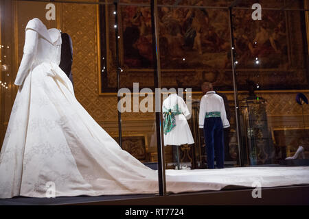 Windsor, UK. 28th Feb, 2019. HRH Princess Eugenie's wedding dress, created by Peter Pilotto and Christopher De Vos of the British-based label Peter Pilotto, and Mr Jack Brooksbank’s morning suit made by tailors at Huntsman on Savile Row, which go on display with other items from their wedding outfits at Windsor Castle  from 1st March to 22nd April. Other items  include the Greville Emerald Kokoshnik Tiara and two diamond wheat-ear brooches. Credit: Mark Kerrison/Alamy Live News Stock Photo