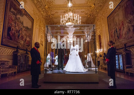 Windsor, UK. 28th Feb, 2019. HRH Princess Eugenie's wedding dress, created by Peter Pilotto and Christopher De Vos of the British-based label Peter Pilotto, and Mr Jack Brooksbank’s morning suit made by tailors at Huntsman on Savile Row, which go on display with other items from their wedding outfits at Windsor Castle  from 1st March to 22nd April. Other items  include the Greville Emerald Kokoshnik Tiara and two diamond wheat-ear brooches. Credit: Mark Kerrison/Alamy Live News Stock Photo