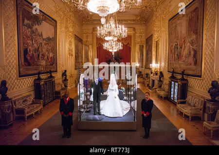 Windsor, UK. 28th Feb, 2019. HRH Princess Eugenie's wedding dress, created by Peter Pilotto and Christopher De Vos of the British-based label Peter Pilotto, and Mr Jack Brooksbank’s morning suit made by tailors at Huntsman on Savile Row, which go on display with other items from their wedding outfits at Windsor Castle  from 1st March to 22nd April. Other items  include the Greville Emerald Kokoshnik Tiara and two diamond wheat-ear brooches. Credit: Mark Kerrison/Alamy Live News Stock Photo