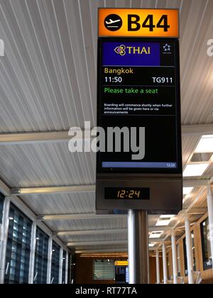 Terminal 2, Heathrow Airport, London, United Kingdom, 28th February 2019. After cancelling all flights between Bangkok and Heathrow yesterday due to the escalation of military tension between Pakistan and India and the closure of Pakistani airspace, Thai Airways flights are rerouted to fly over Chinese airspace. The backlog of passengers caused significant delays. The 11.50am flight from London to Bangkok was delayed until after 14.00 to cope with the backlog of passengers. The journey time was 2 hours longer and hundreds of passengers missed onward connections Stock Photo