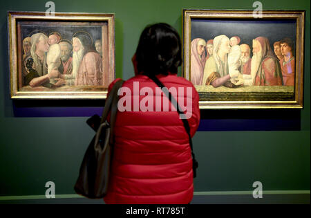 Berlin, Germany. 28th Feb, 2019. A visitor of the exhibition 'Mantegna and Bellini. Master of the Renaissance' in the Picture Gallery at the Cultural Forum looks at the paintings 'The Presentation of Christ in the Temple' (r) by Giovanni Bellini and 'The Presentation of Christ in the Temple' by the artist Andrea Mantegna. The special exhibition of the National Museums in Berlin and the National Gallery London in cooperation with the British Museum runs from 01.03.2019 to 30.06.2019. Credit: Britta Pedersen/dpa/Alamy Live News Stock Photo