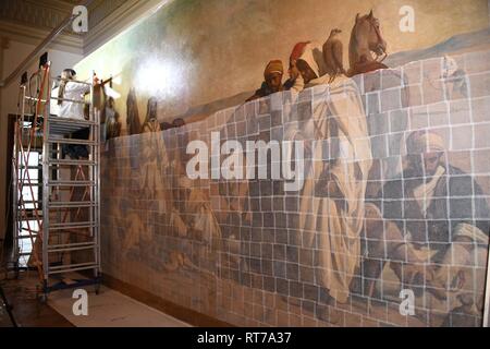 (190228) -- ISTANBUL, Feb. 28, 2019 (Xinhua) -- Staff members repair an Orientalist painting in the Painting Museum in Istanbul, Turkey, Feb. 25, 2019. The art piece, known as the largest Orientalist painting in Turkey, had been on display in the mansion in the Sariyer district for almost 140 years until the Presidency of National Palaces Administration added it lately into its collections and started an all-out restoration.  TO GO WITH Feature: 154-year-old Orientalist painting under restoration at new home in Istanbul (Xinhua/Xu Suhui) Stock Photo