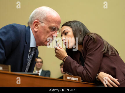 Washington, United States Of America. 27th Feb, 2019. United States Representative Peter Welch (Democrat of Vermont), left, and US Representative Alexandria Ocasio-Cortez (Democrat of New York), right, in conversation as Michael Cohen, Former attorney to US President Donald J. Trump, testifies before the US House Committee on Oversight and Reform on Capitol Hill in Washington, DC on Wednesday, February 27, 2019. Credit: Ron Sachs/CNP (RESTRICTION: NO New York or New Jersey Newspapers or newspapers within a 75 mile radius of New York City) | usage worldwide Credit: dpa/Alamy Live News Stock Photo