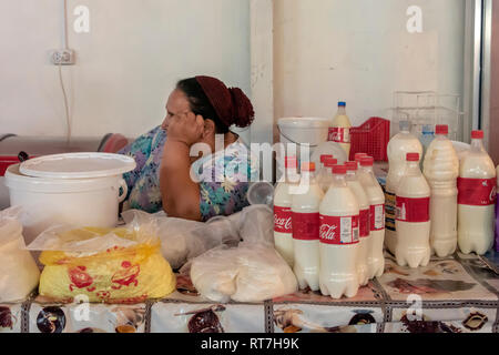 Fresh milk for sale in plastic coke bottles, Shymkent market, Kazakhstan. Stock Photo