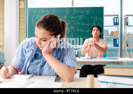 Young students taking the math exam in classroom Stock Photo