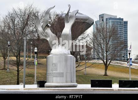 Chicago, Illinois, USA. The monument and statue named the 'Eternal Flame of Hope' in a light snow in the midst of winter in the city. Stock Photo