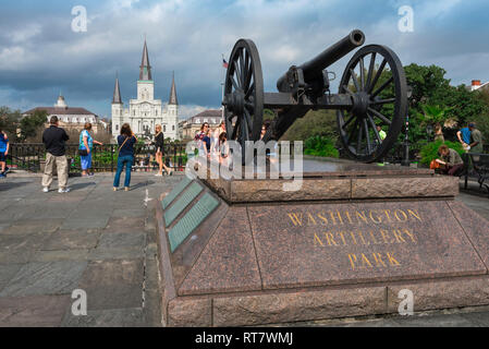 View of an original Louisiana militia cannon sited in the Washington Artillery Park with St Louis Cathedral visible in the distance, New Orleans, USA Stock Photo