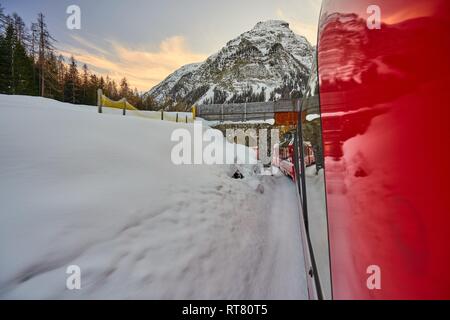 The Bernina Express Red Train through the Alps Stock Photo