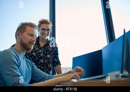 Two colleagues working together in office Stock Photo