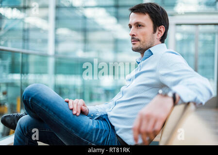 Businessman waiting in airport departure area Stock Photo
