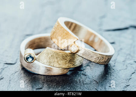 Silver and gold ring with blue sapphire and brilliant on slate Stock Photo