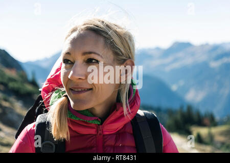 Austria, Tyrol, portrait of smiling woman on a hiking trip in the mountains Stock Photo