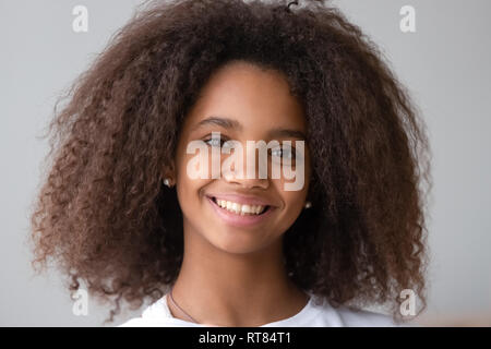 Attractive black teenager girl smiling looking at camera Stock Photo