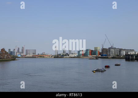 Buildings, including the Optic Cloak, create an urban skyline along the River Thames in London, as seen from Greenwich, United Kingdom. Stock Photo