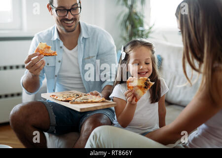 Portrait of happy family sharing pizza at home Stock Photo