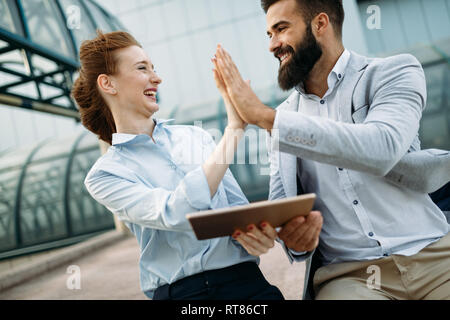 Business partners workmate couple talking in an urban city Stock Photo