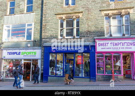 Shops in Keswick town centre including temple sports and Cancer research uk, Cumbria,Lake District national park,England Stock Photo